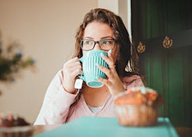 Woman Drinking On A Green Ceramic Mug